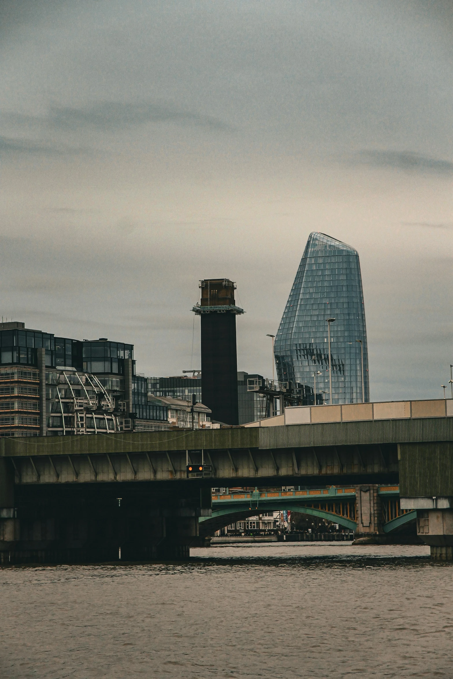 city skylines including a river, bridge, and tall buildings with tall windows