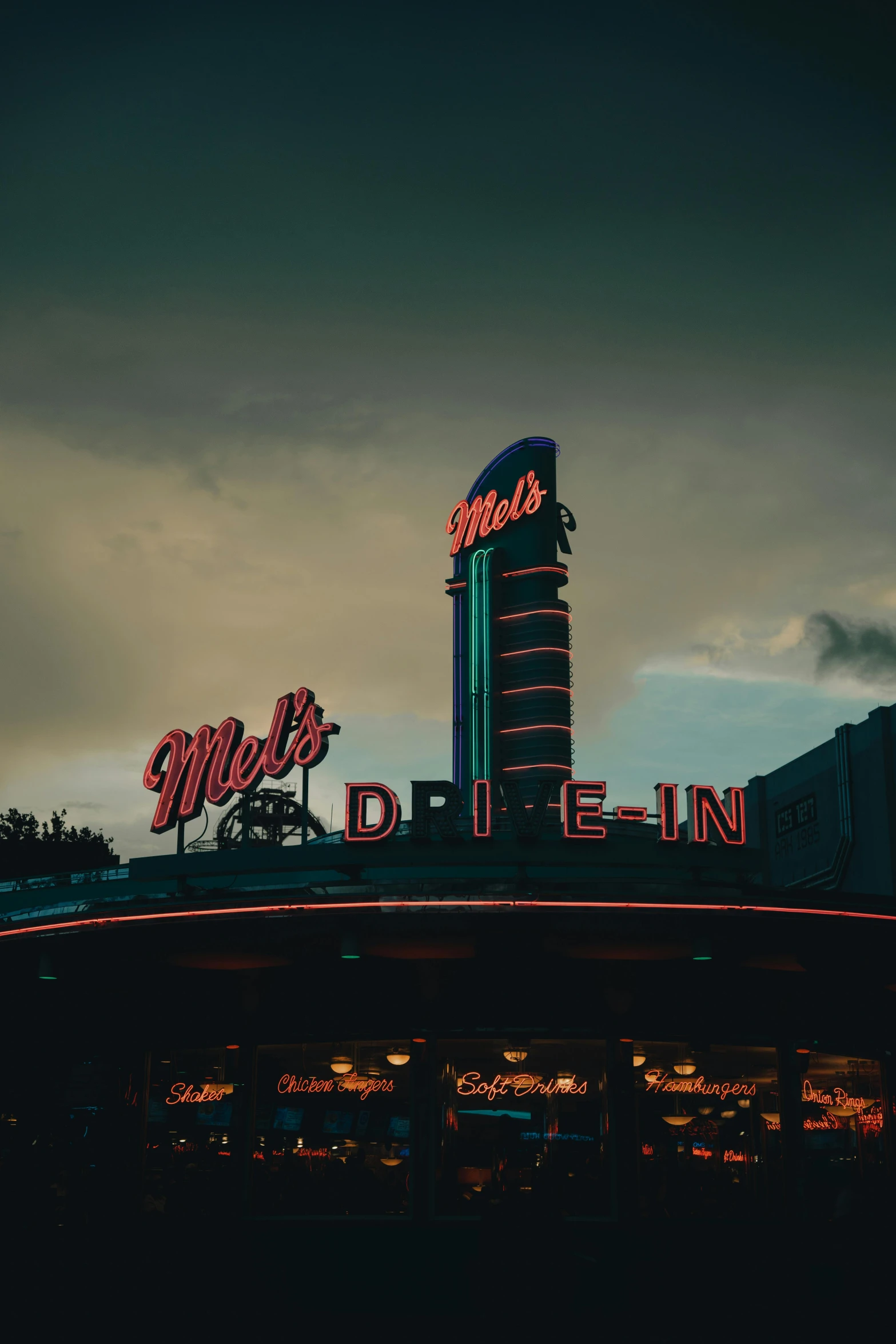 the neon signs are showing at night time