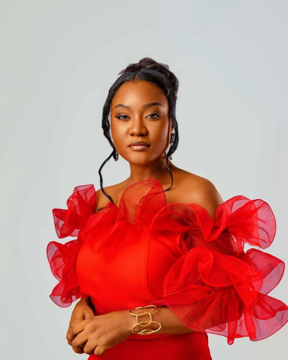 an african american woman in red dress posing