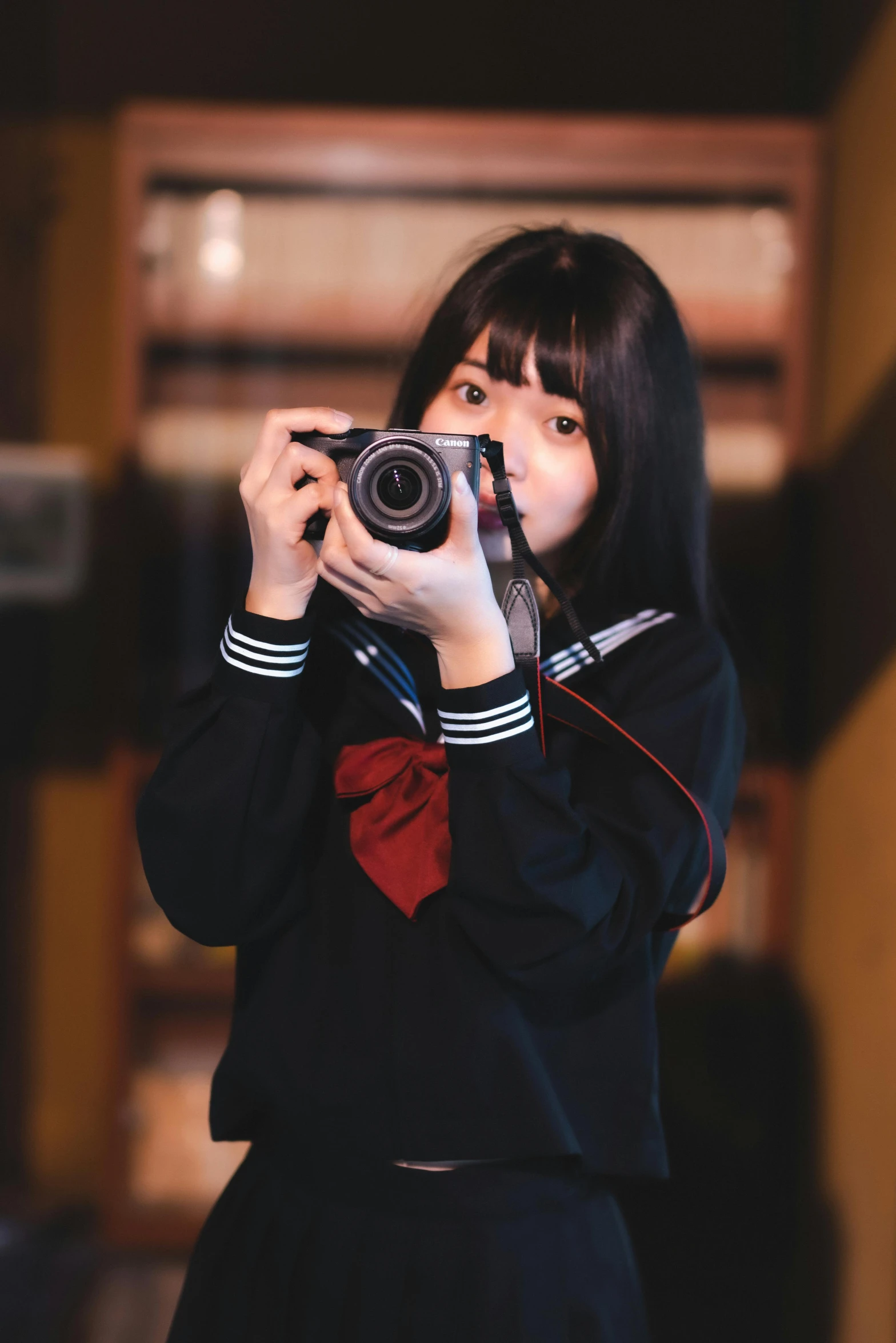 a woman holding a camera up to take a picture