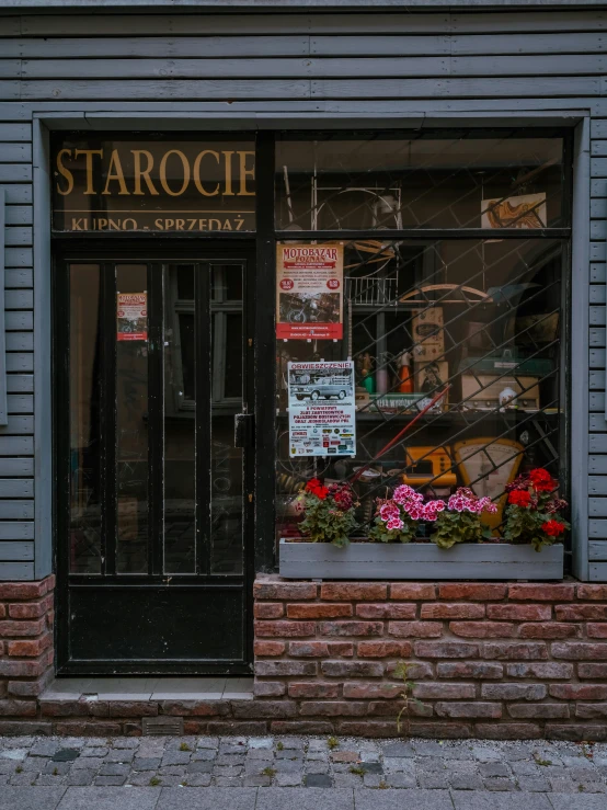 a storefront with a glass window and some signs