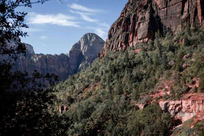 the mountain tops are red and green under blue skies