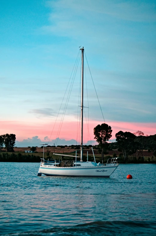 a sailboat is sitting on the water by itself