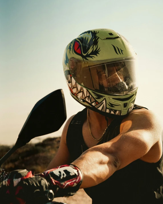 a man wearing a painted mask rides on a motorcycle