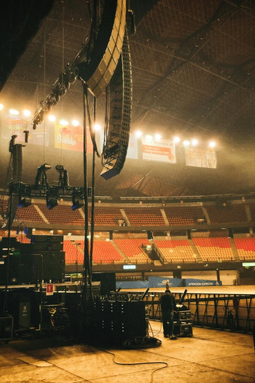 the empty seating in an arena area under heavy rain