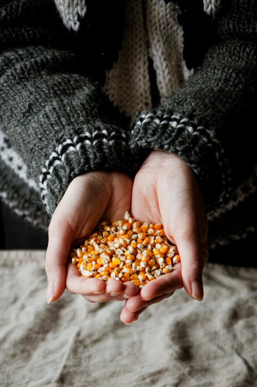 person holding their hands out while looking at the grain