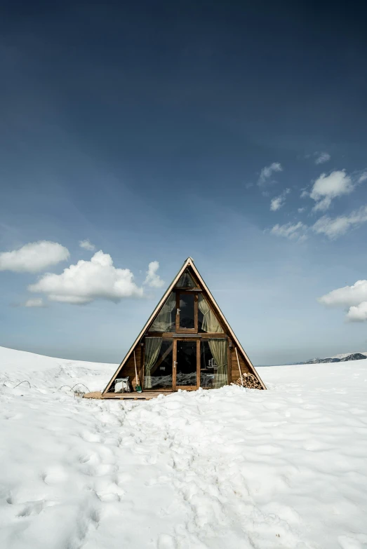 a small wooden house on the snowy shore