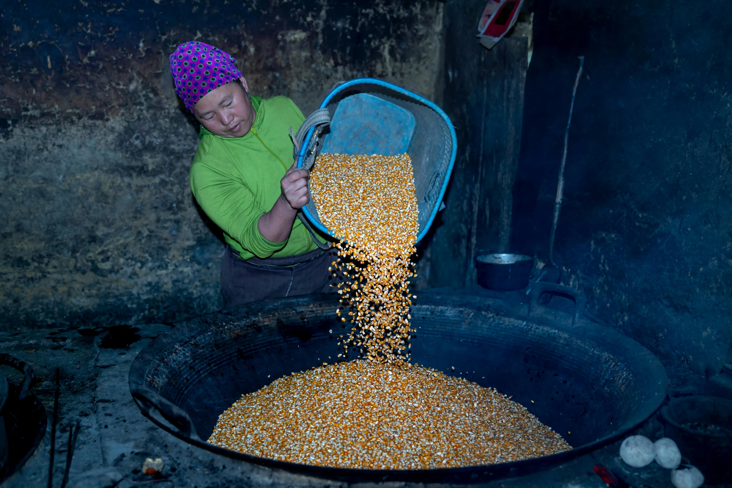 there is a woman pouring soing into a large bowl