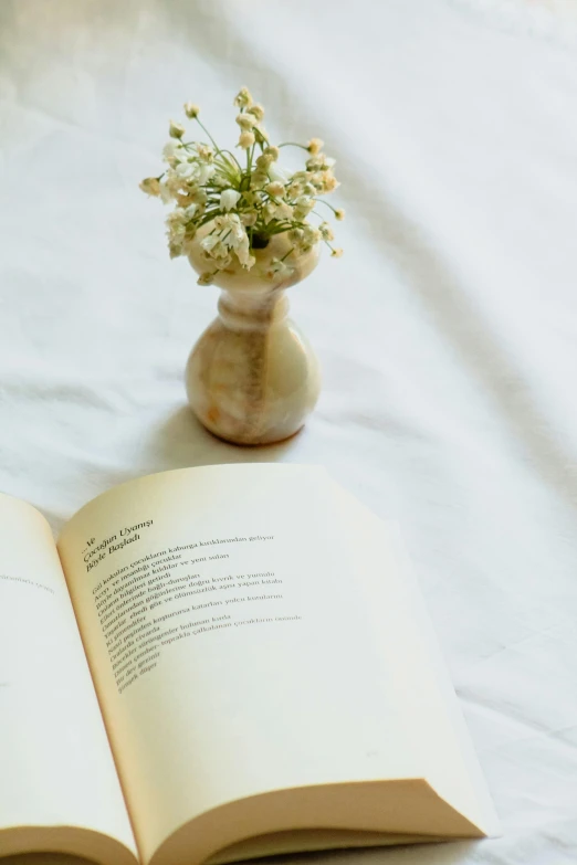 a book on the table with flowers in it