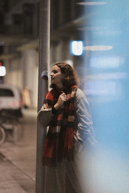 the young woman is standing on the side of the road