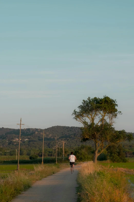 a person walking down the road toward the horizon