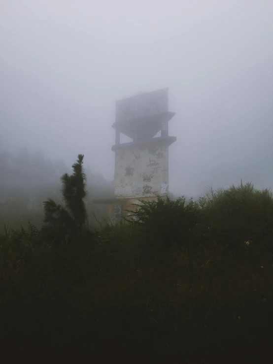 a tower with a clock on top of it surrounded by trees