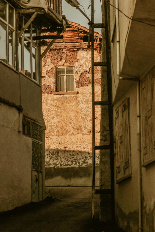 a window in an old building that has graffiti on the walls