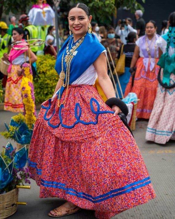 two women in colorful dress walking past people