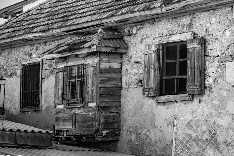 an old house with a window on a street