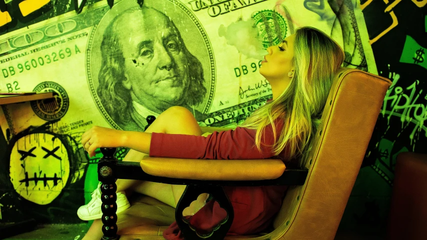 a girl sitting in a chair near a bunch of money