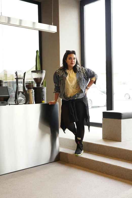 a woman standing on steps near a counter