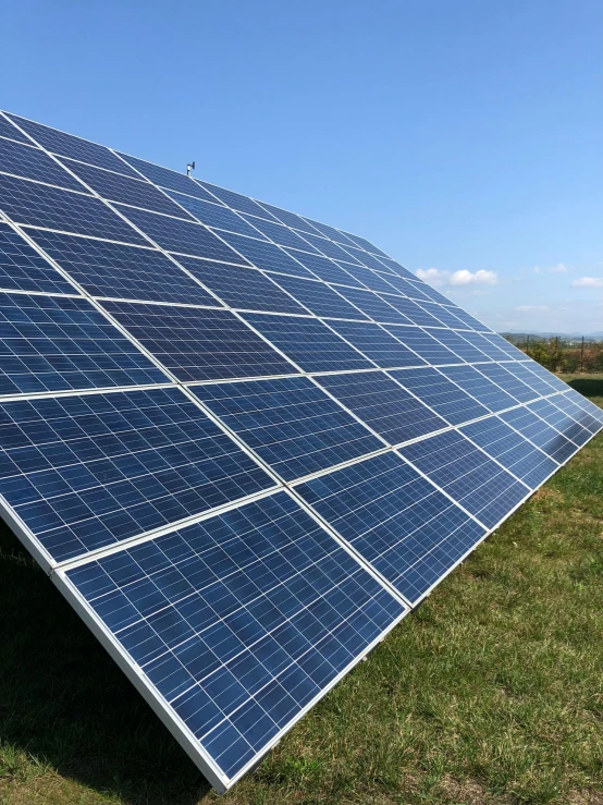 solar panels are shown in the foreground against a bright blue sky