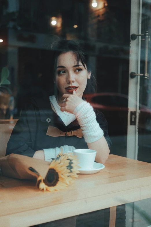 a woman sitting at a table with her food