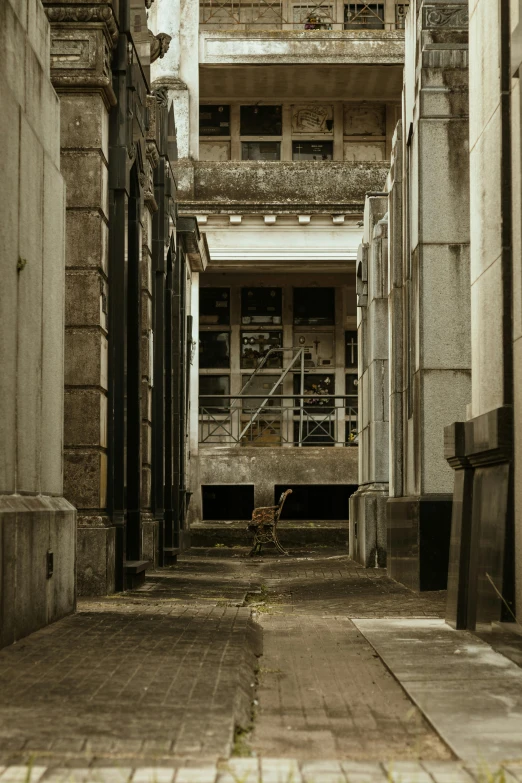 a sidewalk has steps and windows with an old building