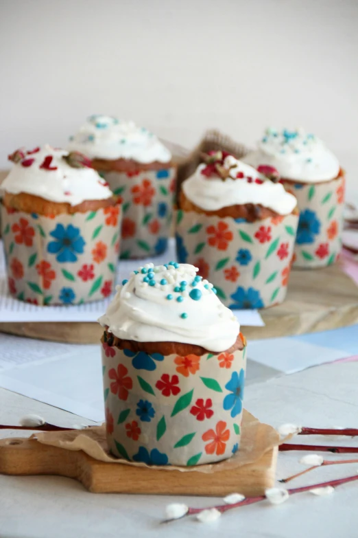 several cupcakes on a tray with flowers on it