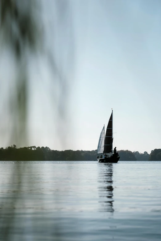 a boat with sails going out to sea