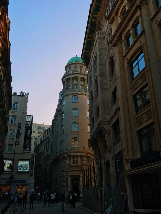 a very tall building next to a couple of buildings