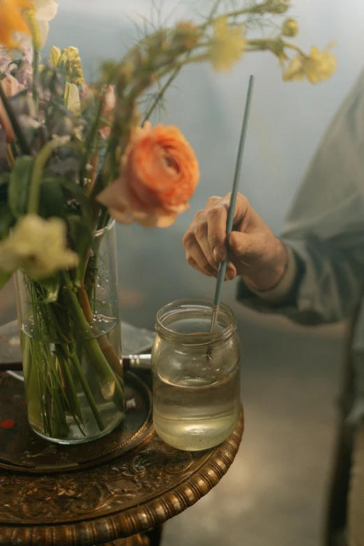 a man is arranging flowers in his vase