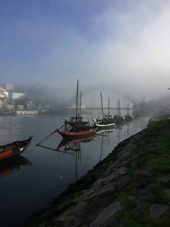 a group of boats floating on top of a river