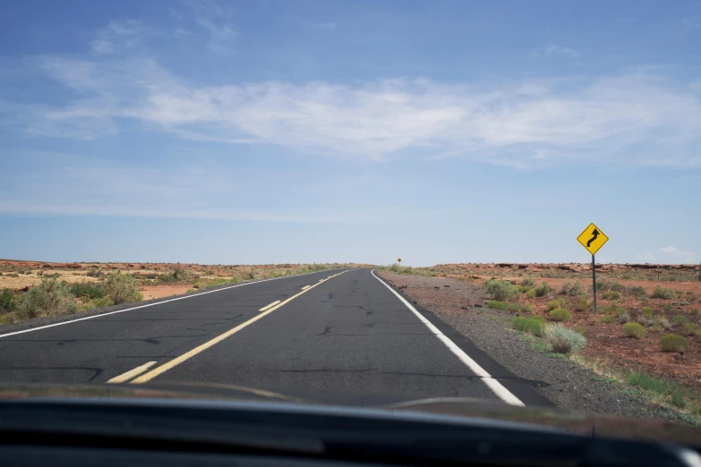 an empty highway with only one direction sign