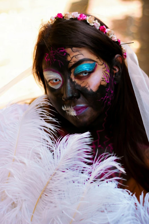 a woman wearing a bridal makeup in white feathers
