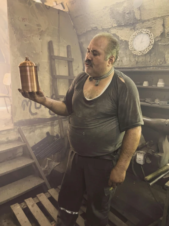 a man in an old kitchen is holding a coffee pot