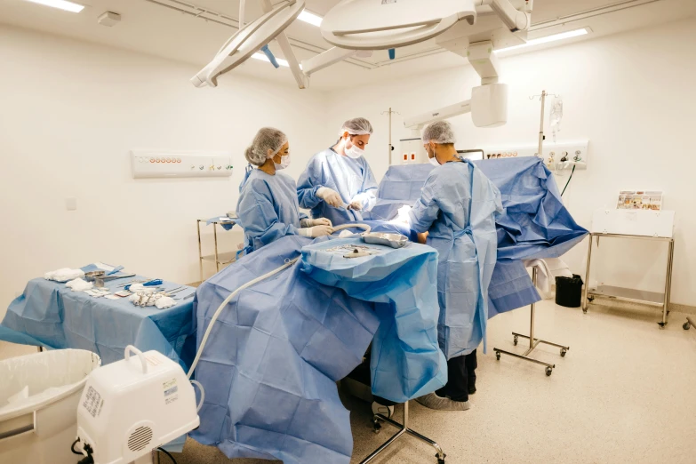 medical personnel performing  in operating room with monitors