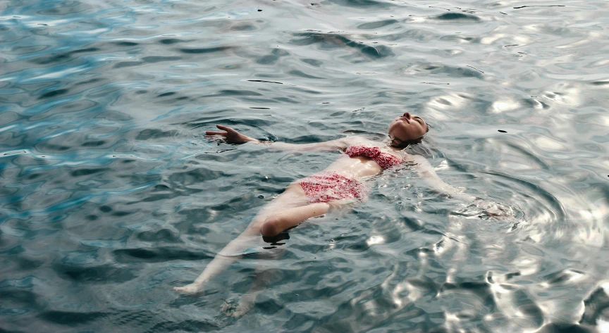 a man swimming in the ocean on a sunny day