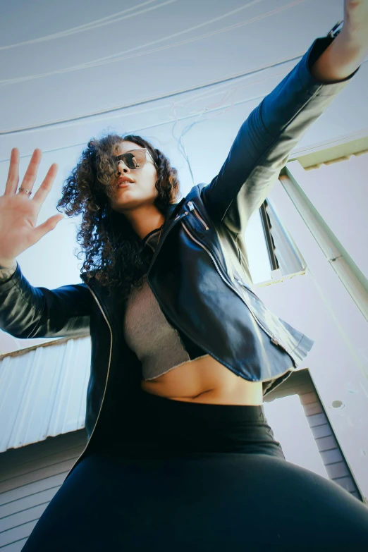 the woman is making her hand stand with her right hand up