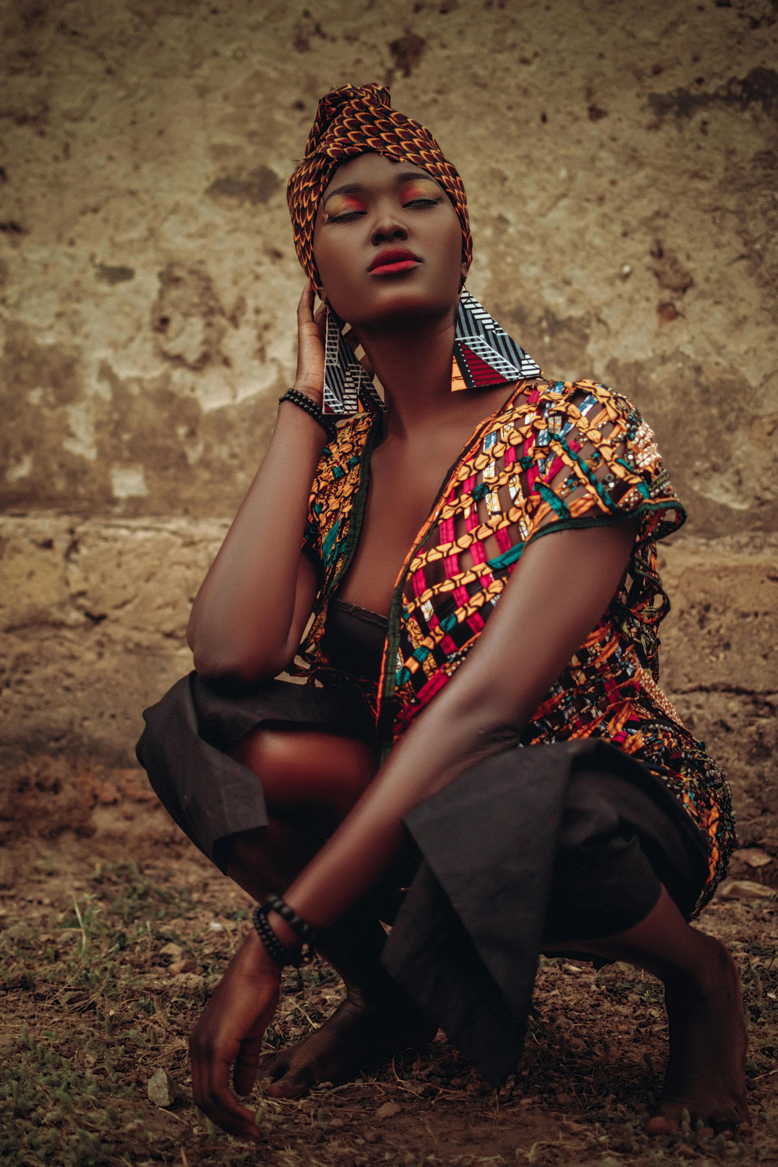 an african woman sitting in the grass