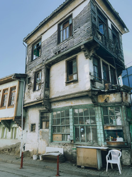 an old dilapidated building sitting on a street corner