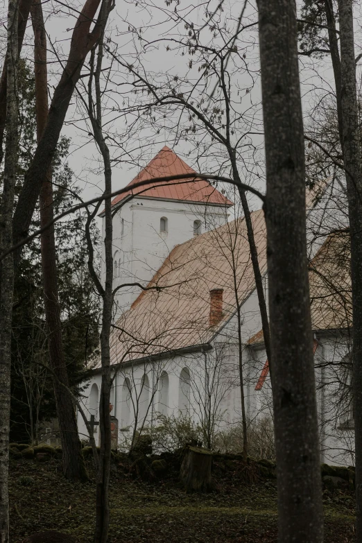 a church sitting in the middle of some trees