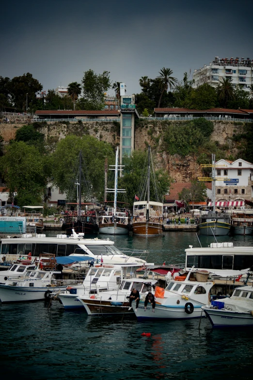 boats in the water next to some city buildings