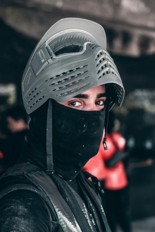 woman in black hood and face mask on a grey background