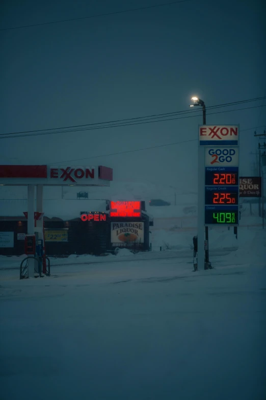 some gas pumps in the snow with lights on