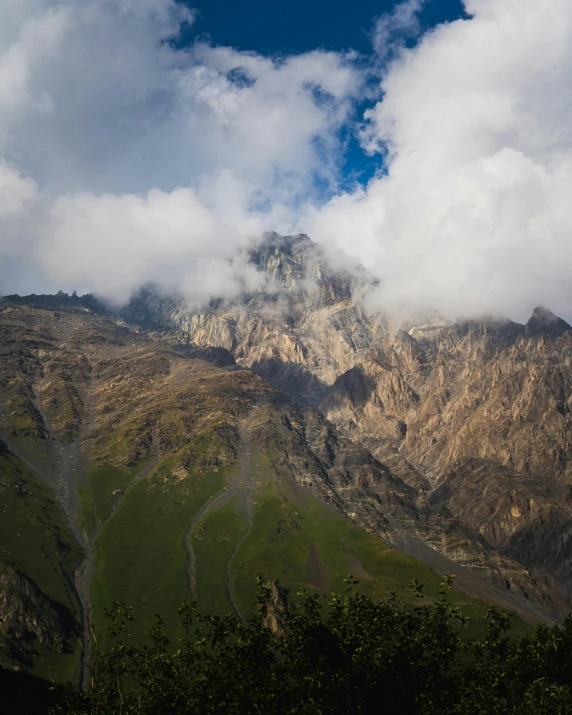 a view of the top of mountains under clouds