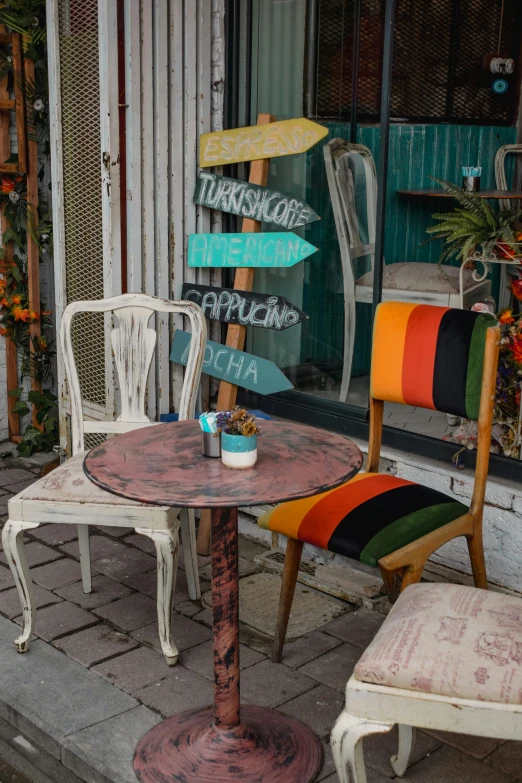 a table and chair with a sign above it