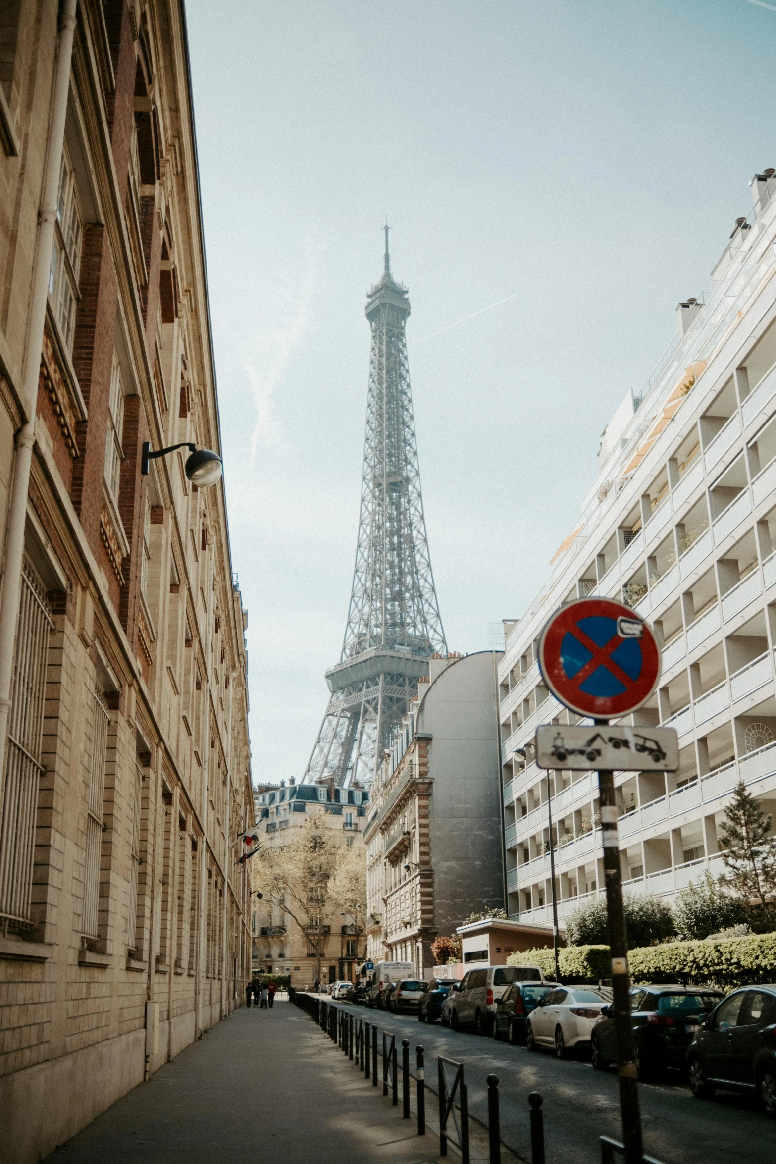 the eiffel tower is seen behind some tall buildings