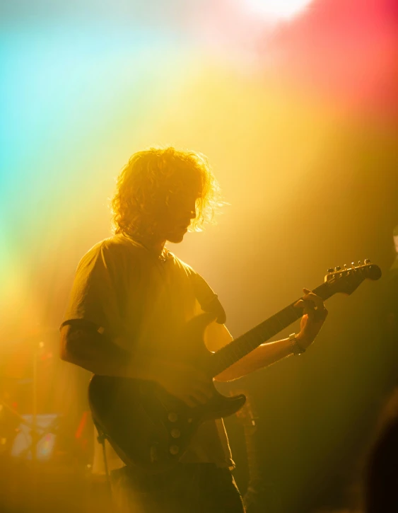 a man playing an electric guitar with his face open
