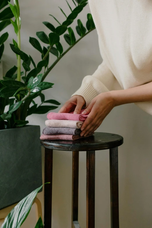 someone rubbing their folded towels onto a stool