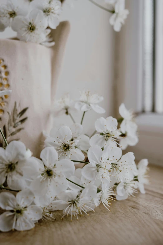 flowers are in a vase beside a window