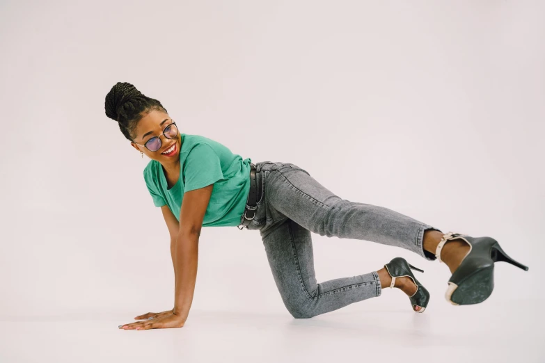 a woman is standing and smiling with her feet in the air