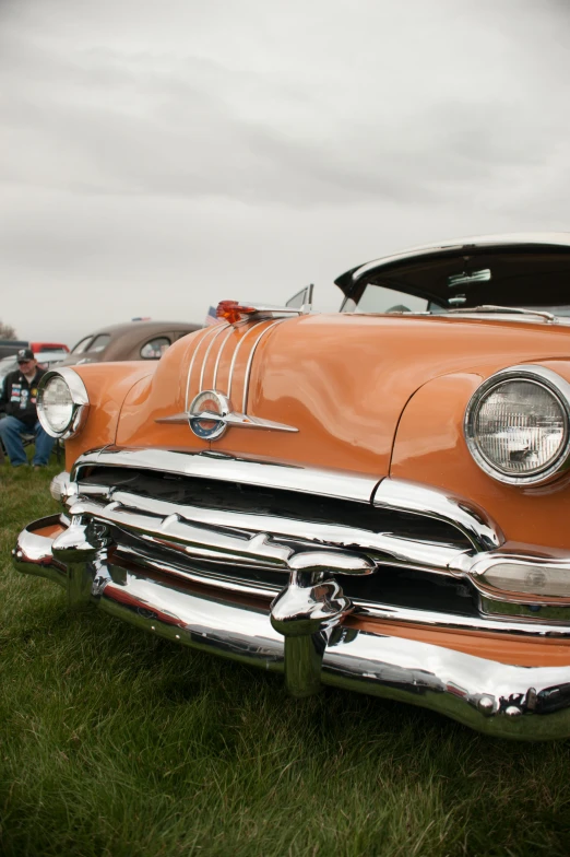 an old car parked in the grass