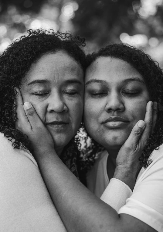 a couple of women hugging each other outdoors